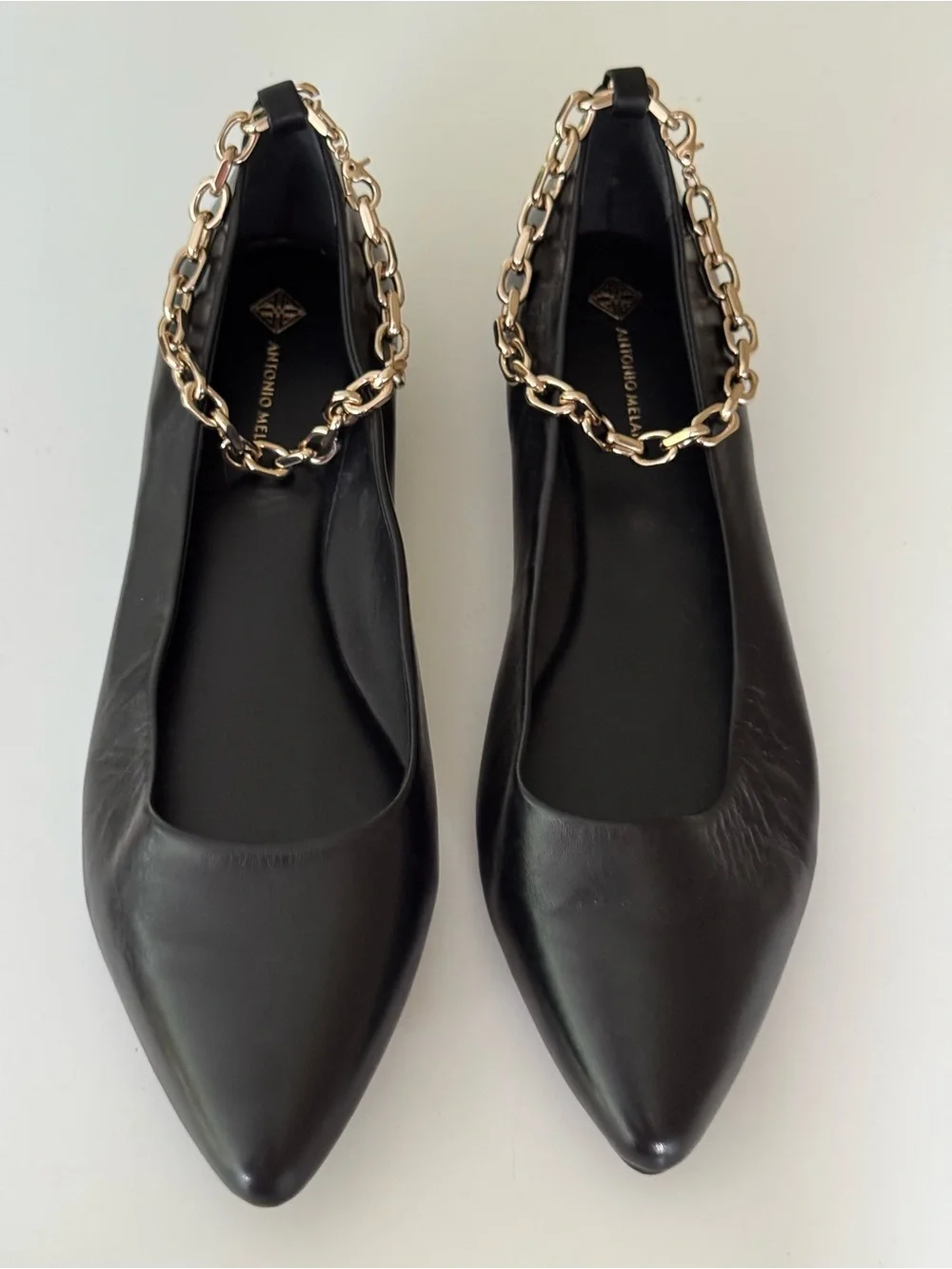 ANTONIO MELANI Black Leather Pointed-Toe Flats with Gold Chain Accent